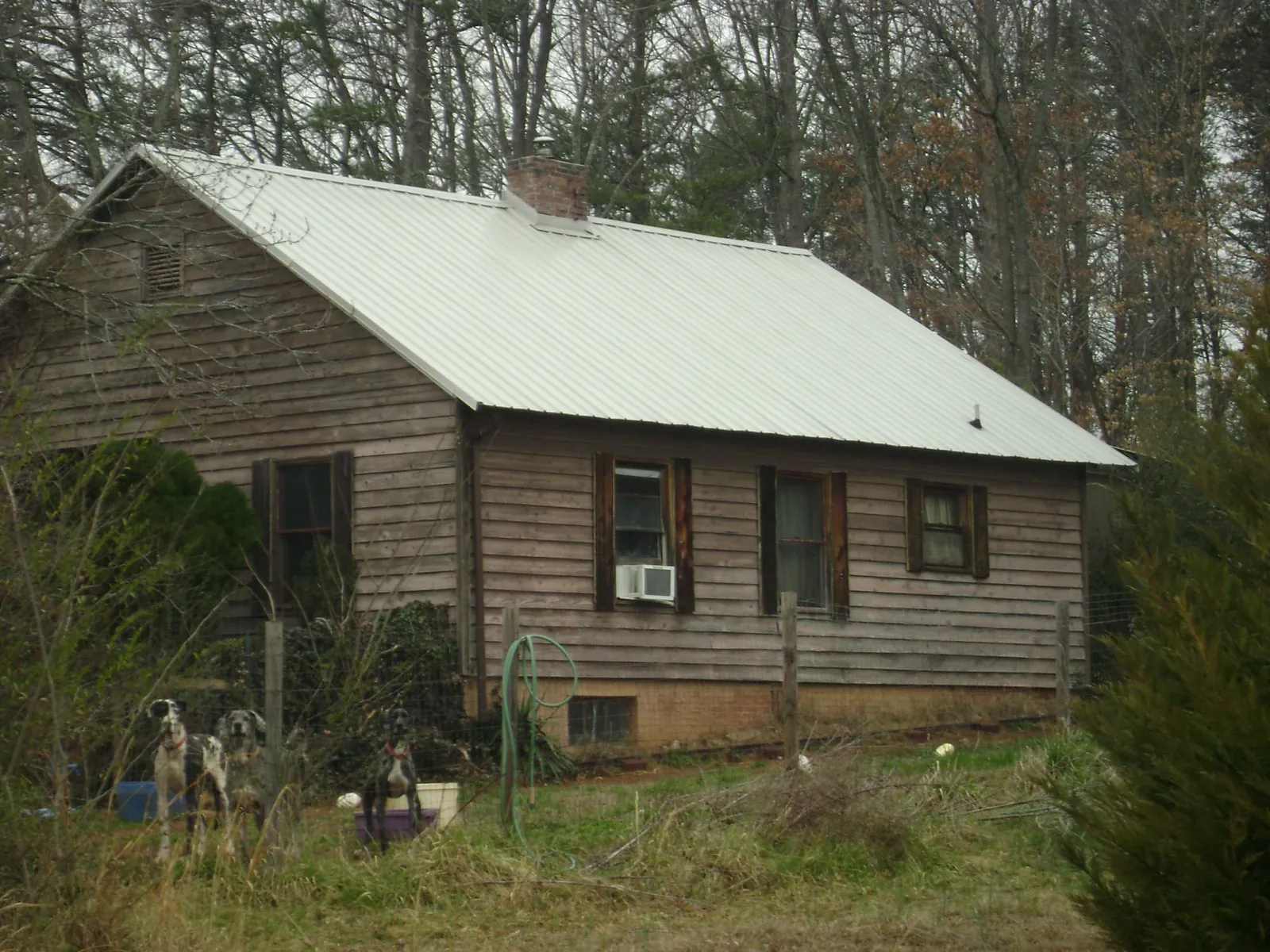 White metal roof on an old wood sided farmhouse, from a Metal Roof Installation job in Fort Jennings